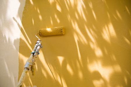 painting a wall with roller.の写真素材