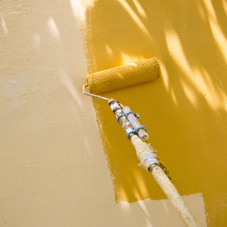 painting a wall with roller.の写真素材