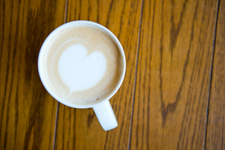 A cup of coffee cappuccino with heart shape.の写真素材