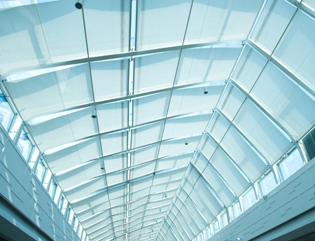 the metal and glass roof of a mallの写真素材