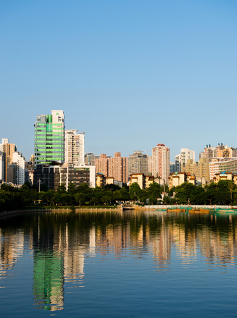 Buildings of a city with reflection in water. Chinaの写真素材