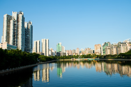 Buildings of a city with reflection in water. Chinaの写真素材