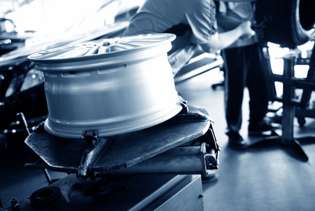 mechanic hands with tool repairing the car at garage.の写真素材