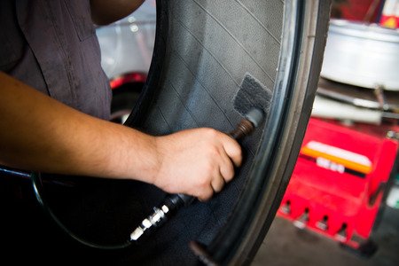 Mechanic making a patch on the rubber.の写真素材