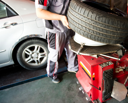 mechanic hands with tool repairing the car at garage.の写真素材