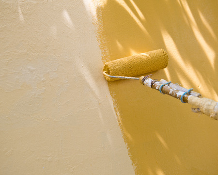 painting a wall with roller.の写真素材