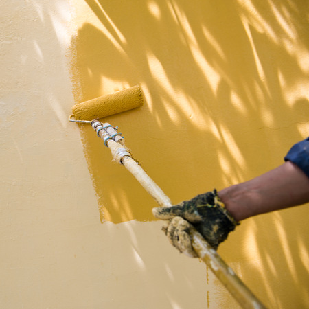 painting a wall with roller.の写真素材