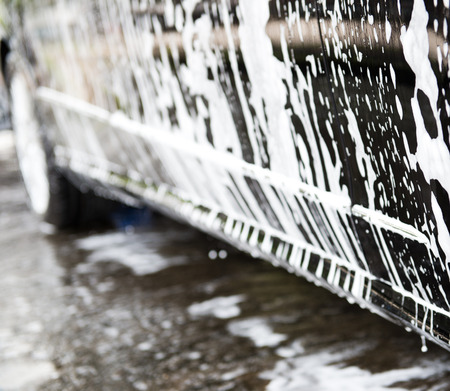 Car wash with flowing water and foam.の写真素材