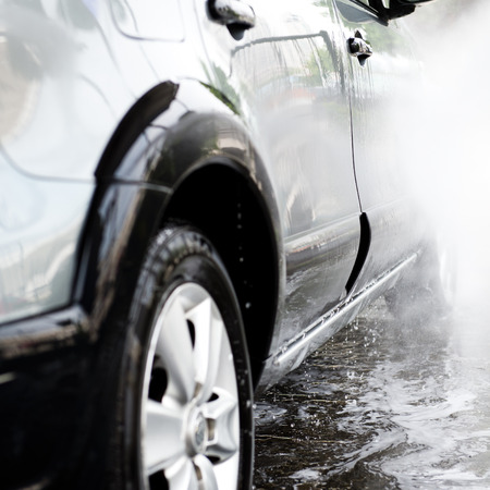Car wash with flowing water and foam.の写真素材
