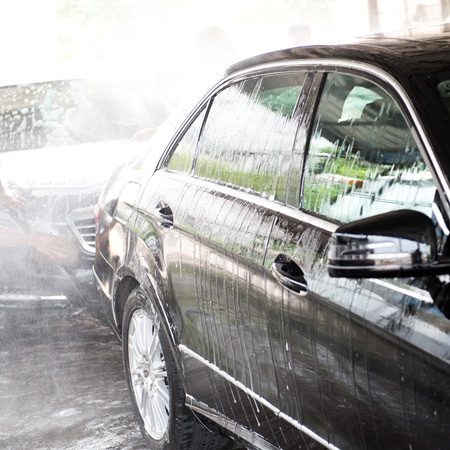 Car wash with flowing water and foam.の写真素材