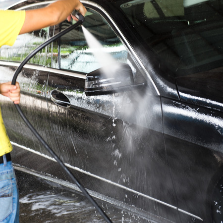 Car wash with flowing water and foam.の写真素材