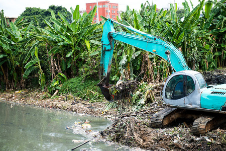 Excavator service in the polluted river.の写真素材