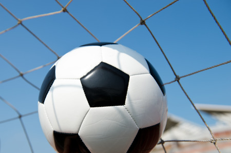 soccer ball in goal. isolated on blue sky backgroundの写真素材