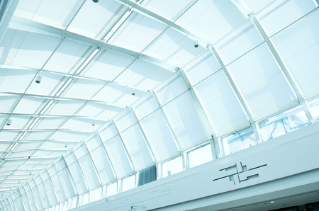 the metal and glass roof of a mallの写真素材