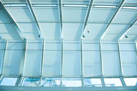 the metal and glass roof of a mallの写真素材