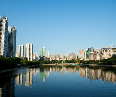 Buildings of a city with reflection in water. Chinaの写真素材