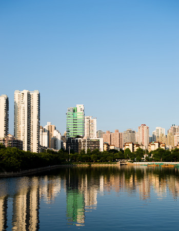 Buildings of a city with reflection in water. Chinaの写真素材