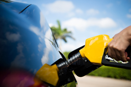 Hand refilling the car with fuel.の写真素材