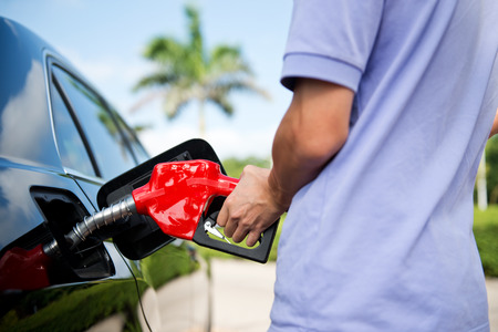 Hand refilling the car with fuel.の写真素材