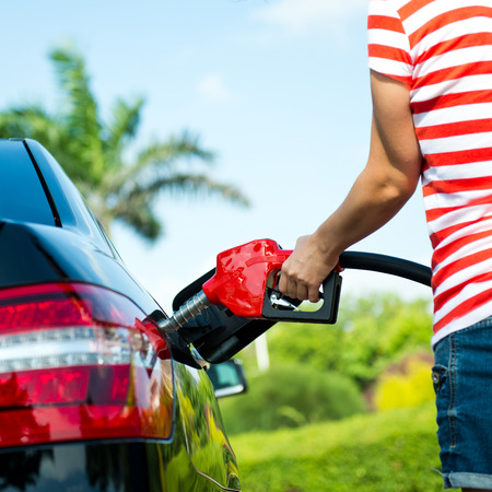 Hand refilling the car with fuel.の写真素材