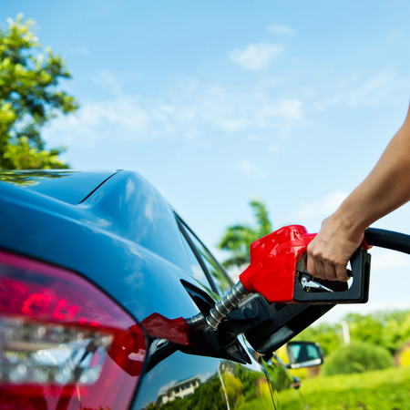 Hand refilling the car with fuel.の写真素材