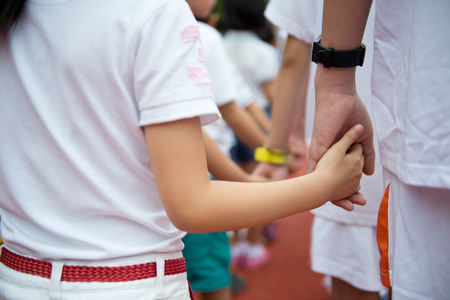 Group of children holding hands together.の写真素材