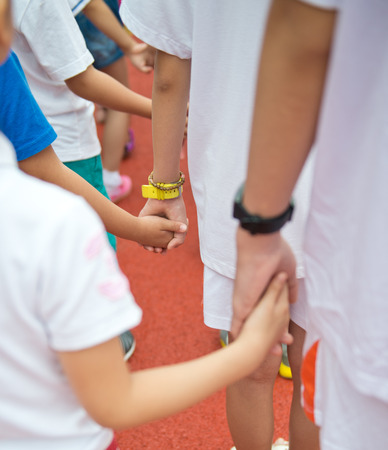 Group of children holding hands together.の写真素材