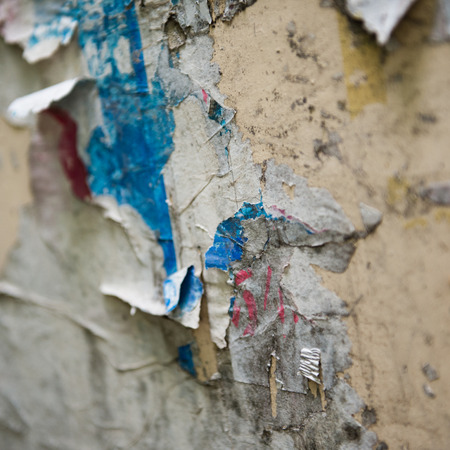 old torn posters on grunge wallの写真素材