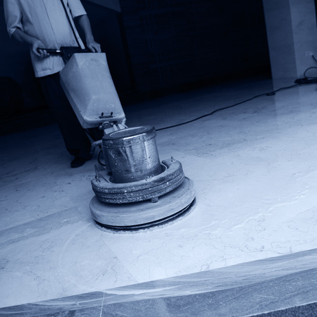 People cleaning floor with machine.の写真素材
