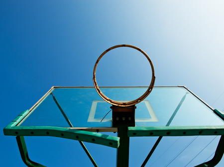 Basketball hoop against blue sky.の写真素材
