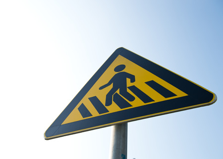 cross walk sign against blue sky.の写真素材