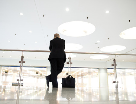 Profile of business people talking on the cellphone in an modern office tower.の写真素材