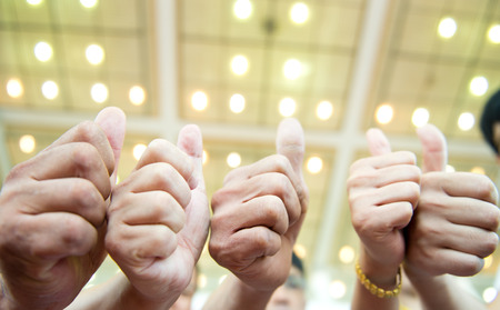 Group of business people holding their thumbs up.の写真素材