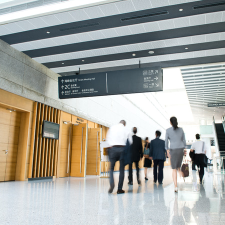 Business people rushing in the lobby. motion blurの写真素材