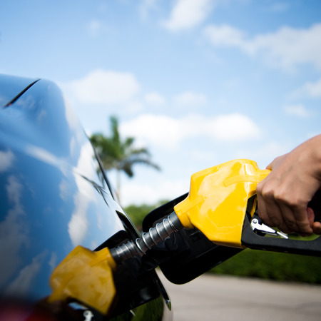 Hand refilling the car with fuel.の写真素材