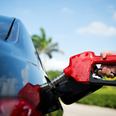 Hand refilling the car with fuel.の写真素材