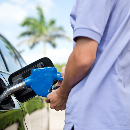 Hand refilling the car with fuel.の写真素材