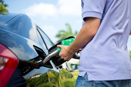 Hand refilling the car with fuel.の写真素材