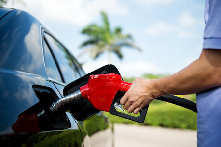 Hand refilling the car with fuel.の写真素材