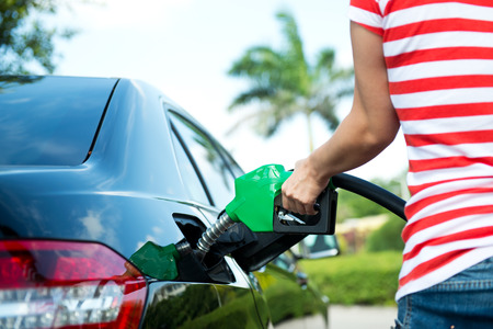 Hand refilling the car with fuel.の写真素材
