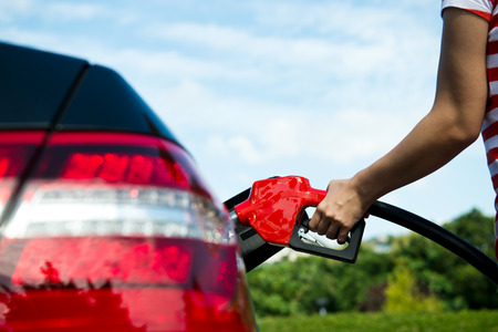 Hand refilling the car with fuel.の写真素材