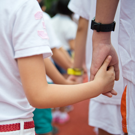 Group of children holding hands together.の写真素材