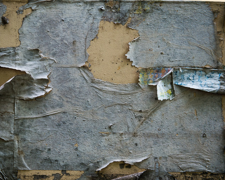 old torn posters on grunge wallの写真素材