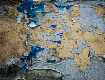old torn posters on grunge wallの写真素材
