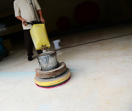 People cleaning floor with machine.の写真素材