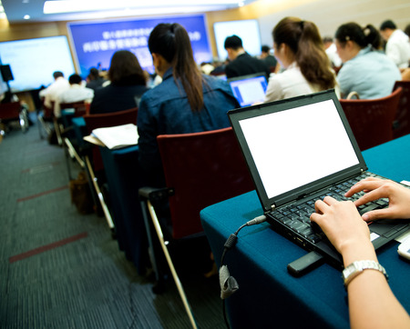 Business people typing on laptop keyboard at conference.の写真素材