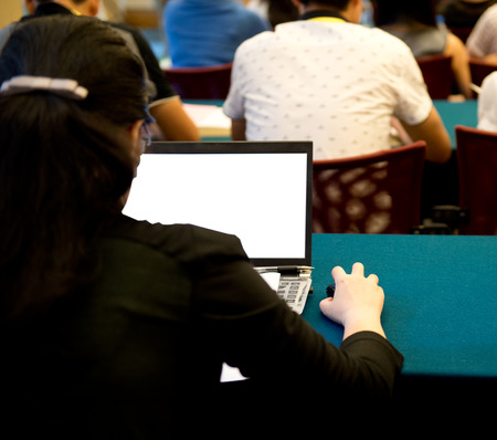 Business people typing on laptop keyboard at conference.の写真素材