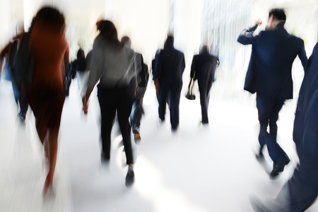 Business people rushing in the lobby. motion blurの写真素材