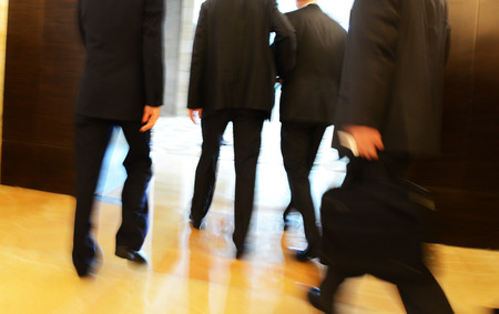 Business people rushing in the lobby. motion blurの写真素材