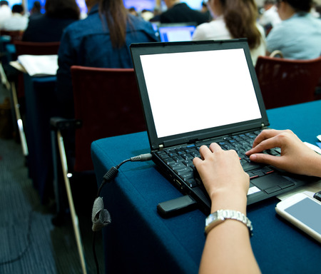 Business people typing on laptop keyboard at conference.の写真素材